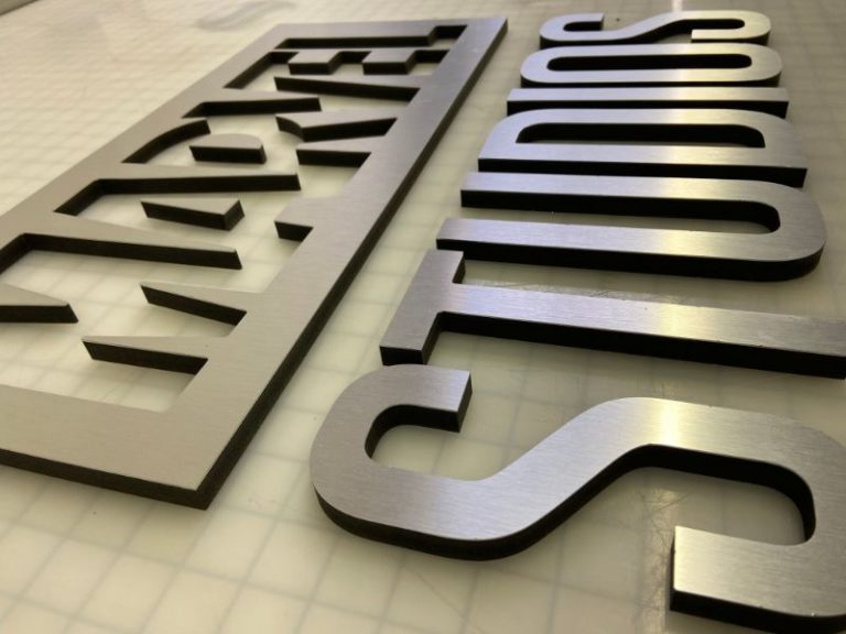 Brushed metal lobby logo signs in Orange County CA