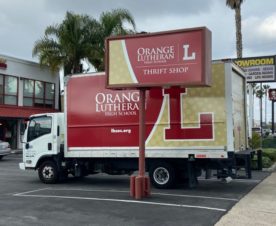 Pylon sign and vehicle graphics in orange, ca