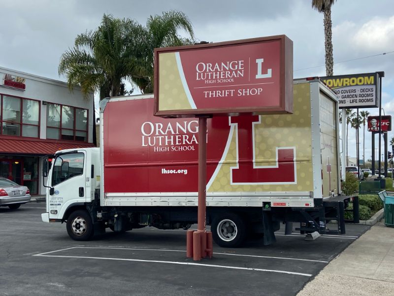 Pylon sign and vehicle graphics in orange, ca