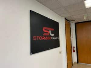 Office wall logo signs mounted with brushed metal wall standoffs in orange, ca